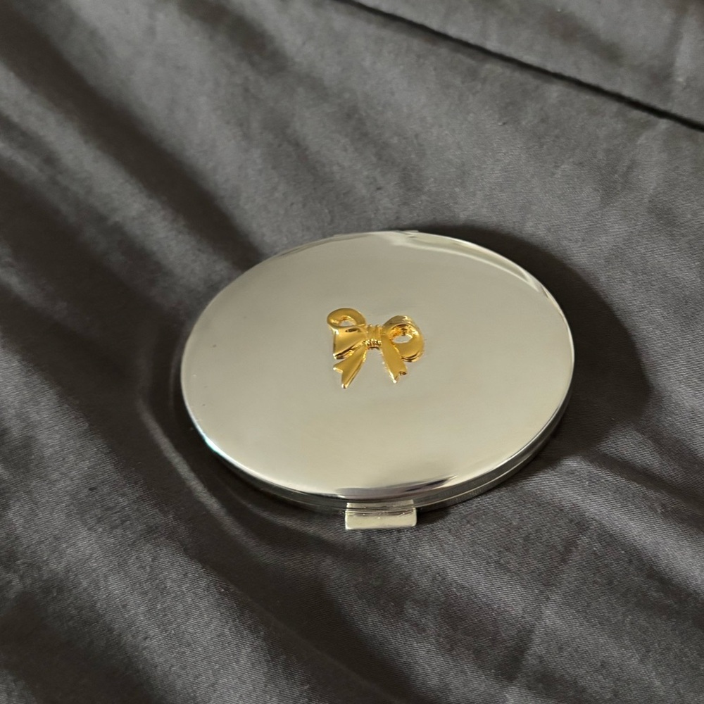 Compact mirror with gold bow